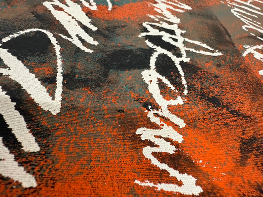 Close-up of an original abstract acrylic painting in orange, black, and teal with expressive palette-knife texture, suited to a corporate boardroom