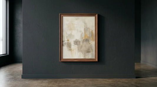 A framed original painting on a dark gallery wall, lit from one side