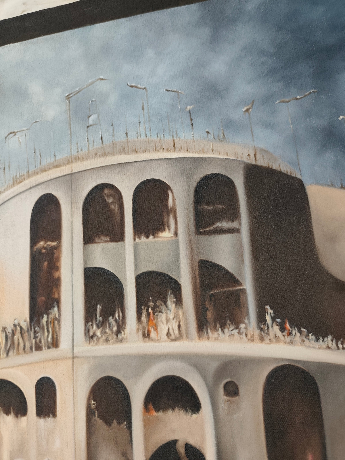 Detail of Why 12? by Melina Ghaemi - the rooftop of the rock-cut city, thin poles and lamp-like forms along the rim, arched niches holding small figures in the tiers beneath.
