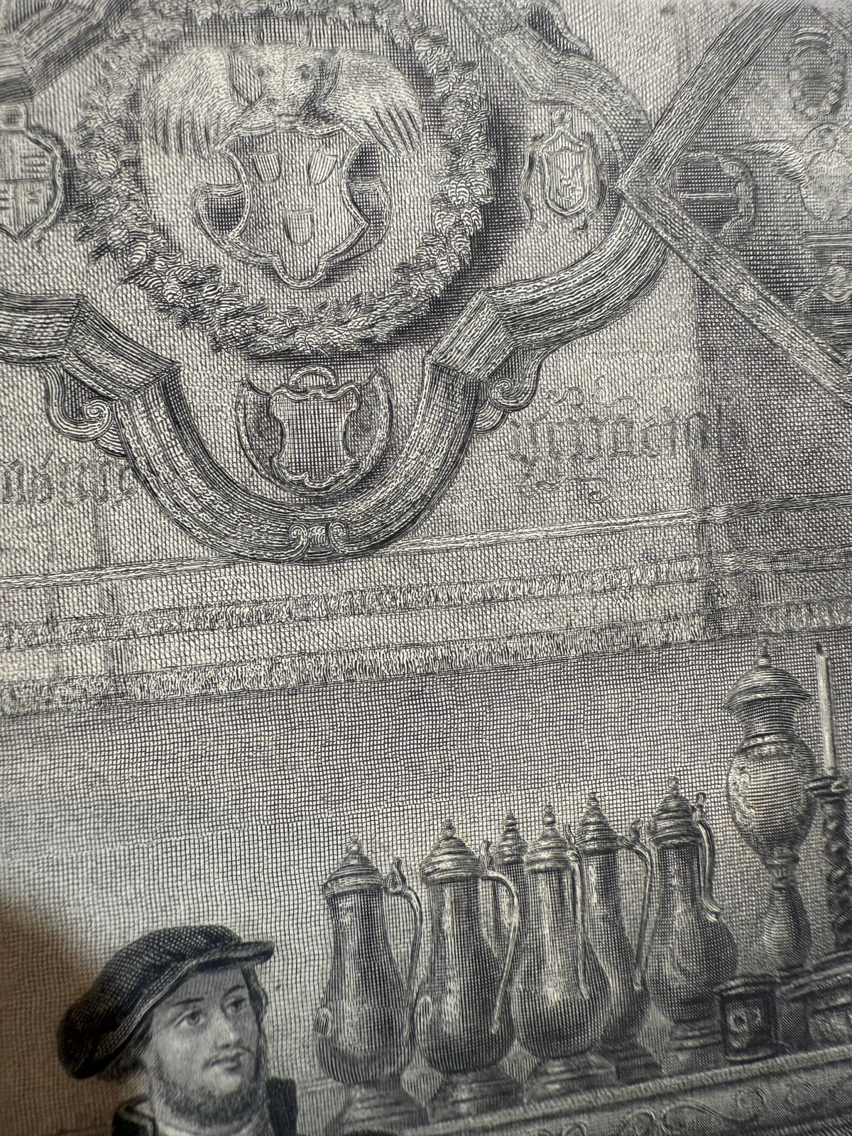 Detail of the wall hanging with a wreathed coat of arms above a row of lidded pewter flagons in The Guests, engraved by J. Greatbach