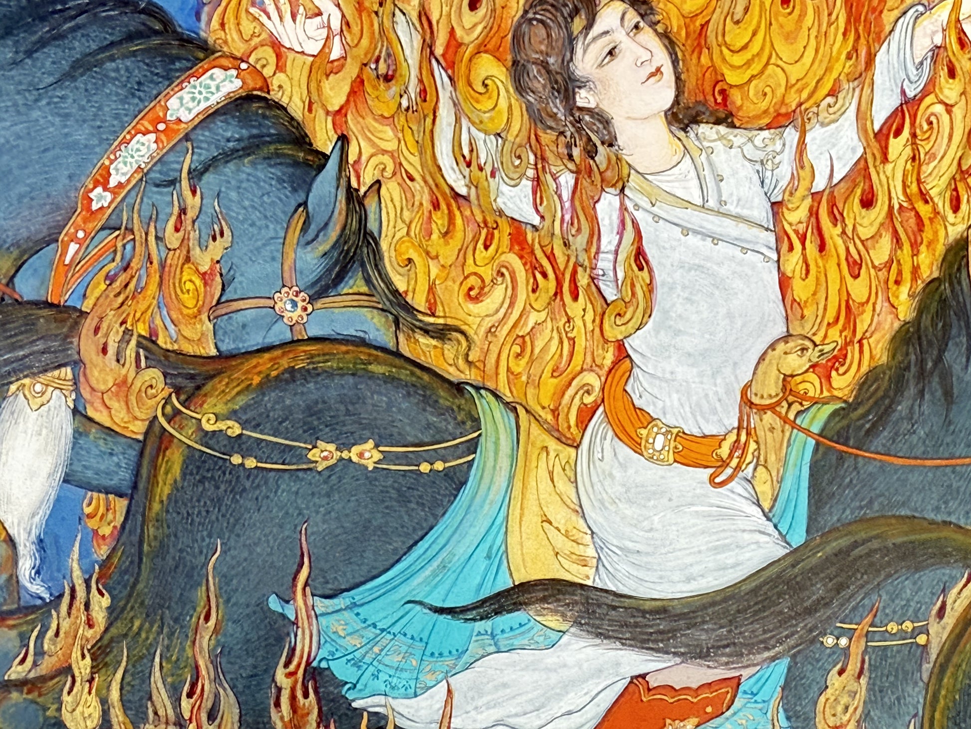 Detail of Siyavash Passing Through the Fire by Kamal al-Din Ghotb - the prince at the heart of the blaze in a white robe and orange jewelled belt, riding a slate-grey horse with a turquoise and gold saddlecloth, his face lifted and calm as flames curl around him
