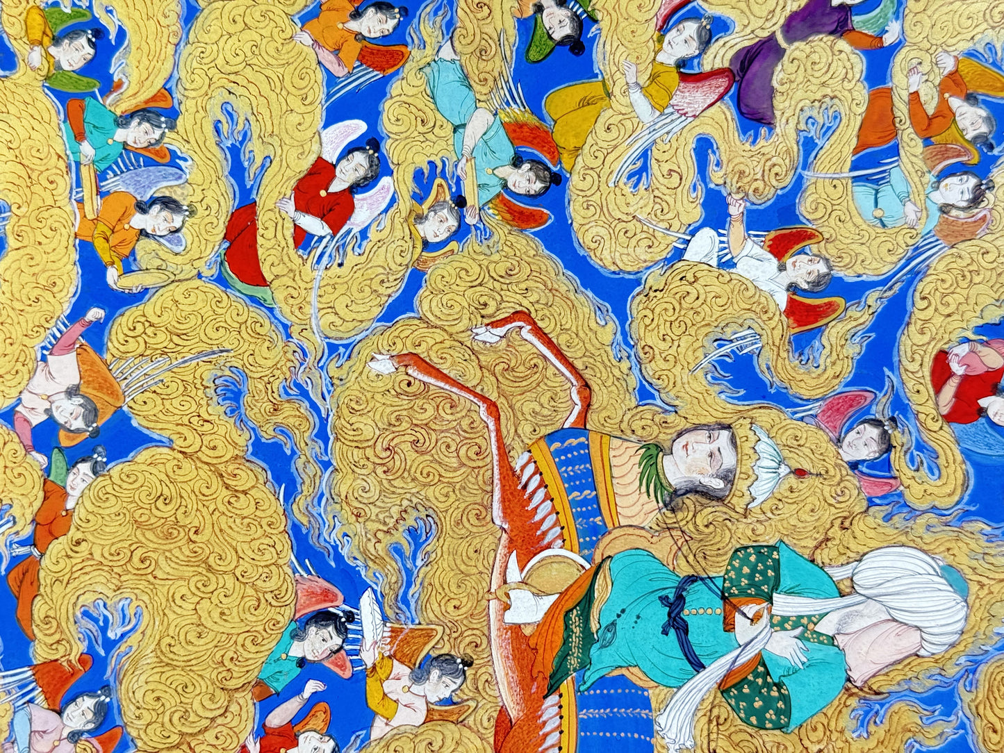 Detail: Buraq's crowned head with its green plume and human face, and the rider's turquoise robe and gold-dotted green sash, surrounded by winged angels in orange, red and yellow among gold cloud scrolls on lapis blue - Mi'raj: The Night Journey, Kamal al-Din Ghotb.