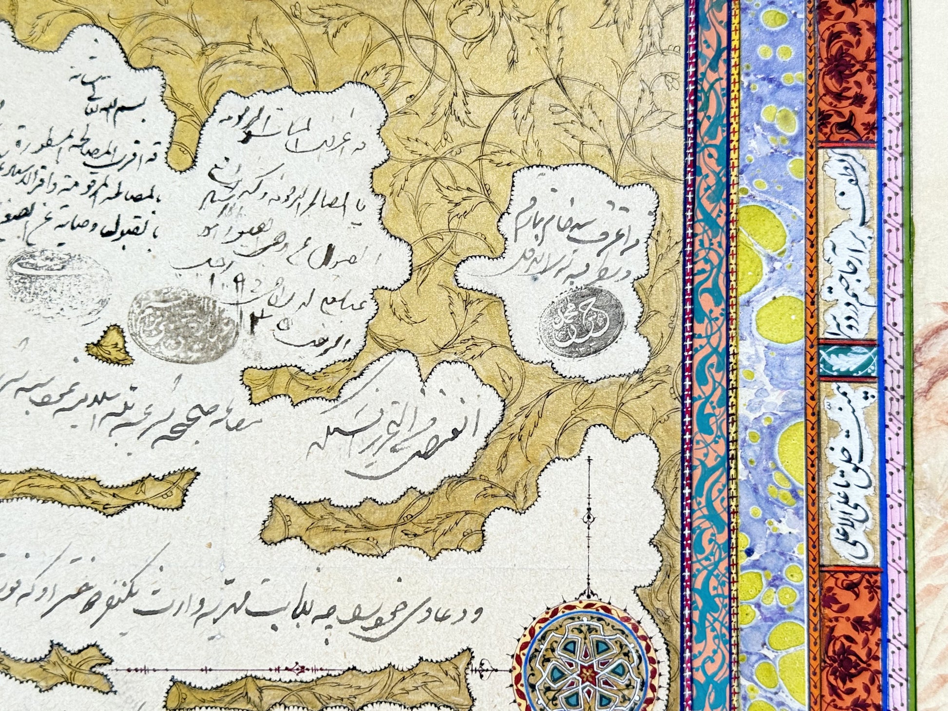 Detail: the calligraphy panel - cloud-shaped reserves of fine running script with oval seal impressions on a gold ground of drawn leaf scrolls, beside a gold-and-lapis shamseh rosette, turquoise arabesque bands and marbled paper - Muraqqa': The Blue Robe, Kamal al-Din Ghotb.