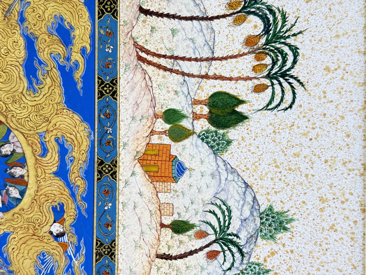 Detail: the gold-speckled margin with date palms, round green trees and a small orange brick building with a blue dome on white rock, beside the illuminated floral border and the gold clouds carrying angels - Mi'raj: The Night Journey, Kamal al-Din Ghotb.