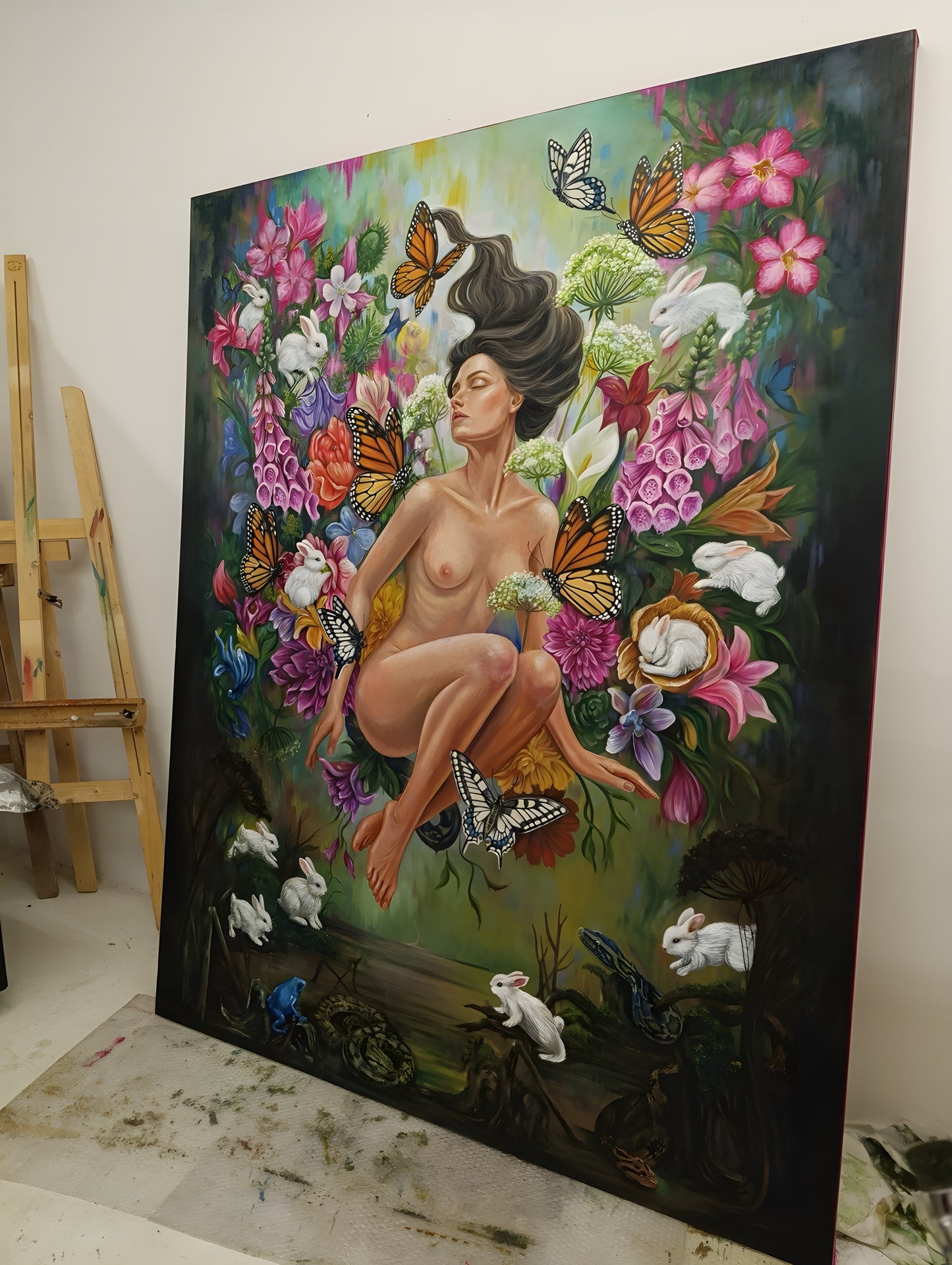 Studio photo: the 140x180 cm original oil painting Ecstasy in a Temporary Paradise standing on the studio floor, seen at an angle to show canvas scale