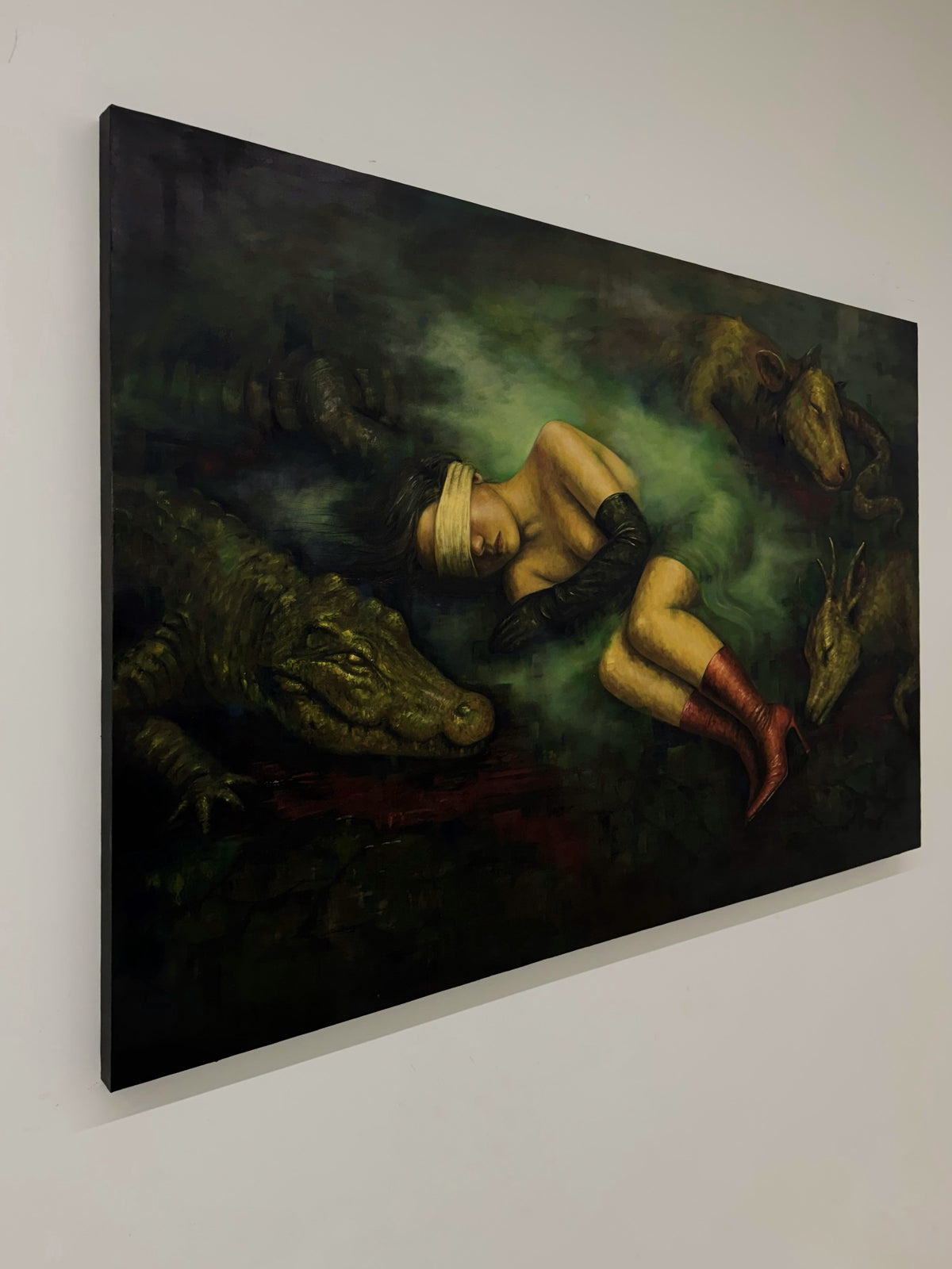 Second Skin by Phaedra on a white wall, angled view from the right with the crocodile's head in the foreground