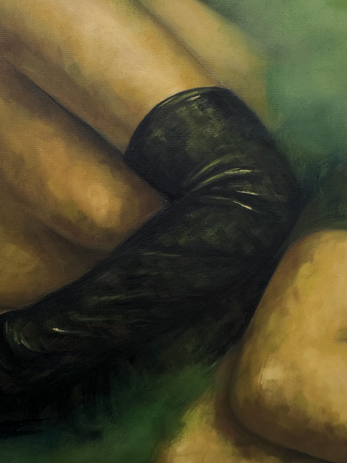 Detail of Second Skin by Phaedra: a long black leather glove folded over the woman's bare arm beside her knee