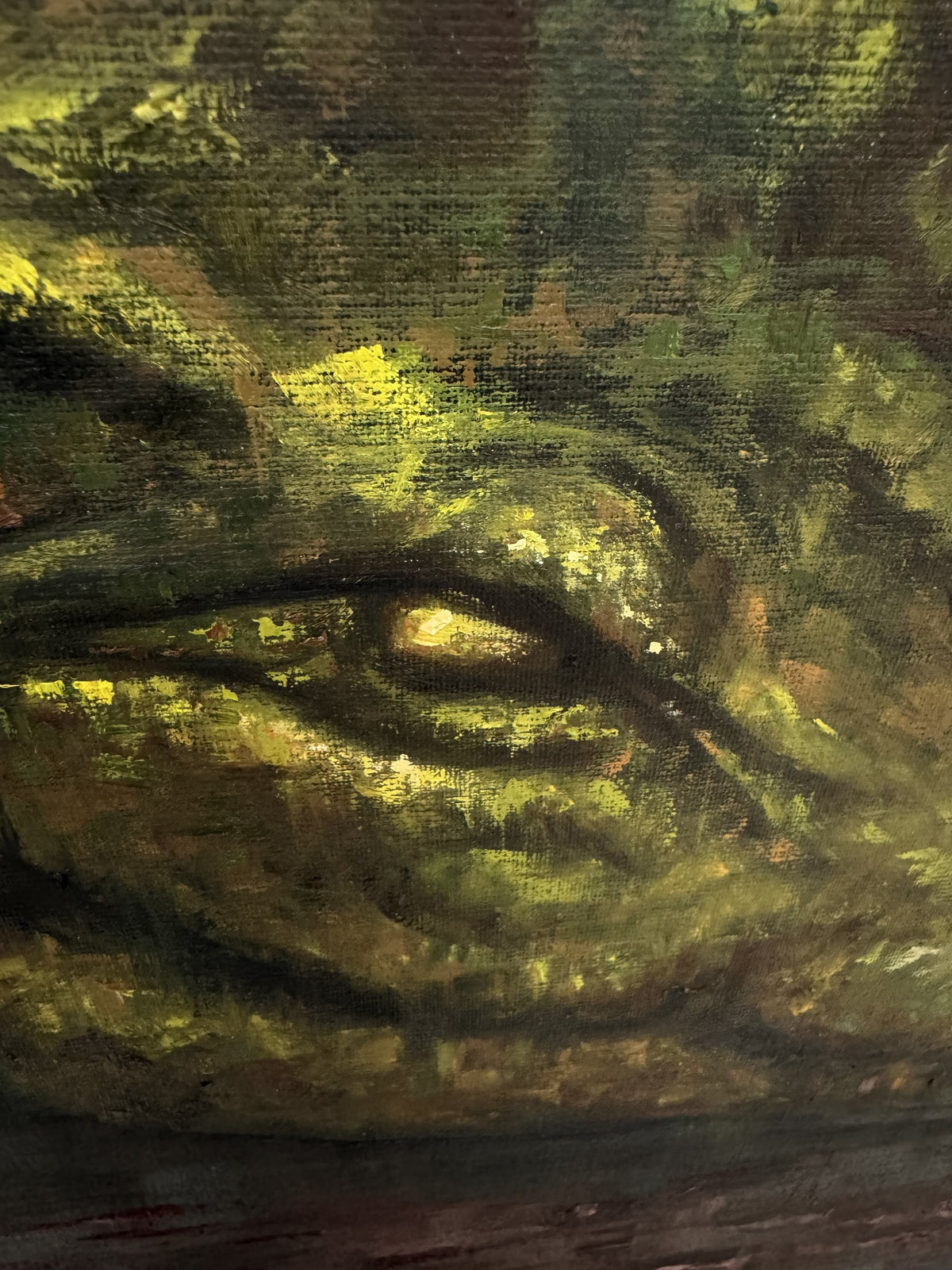 Detail of Second Skin by Phaedra: the crocodile's half-closed eye painted in yellow-green impasto on textured canvas