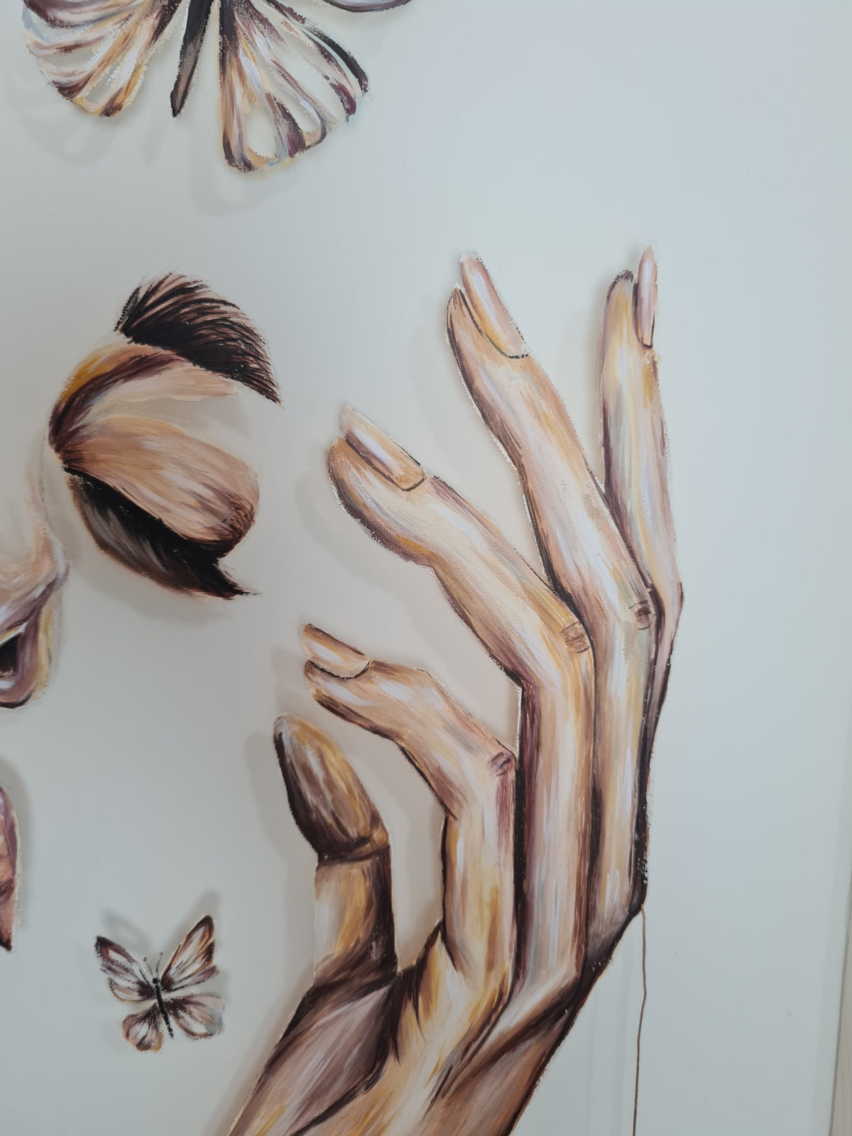 Threads of Becoming by Mahdiye, close-up of the right hand with long tapered fingers in warm ochre and umber brushwork, beside a closed eye and a small butterfly