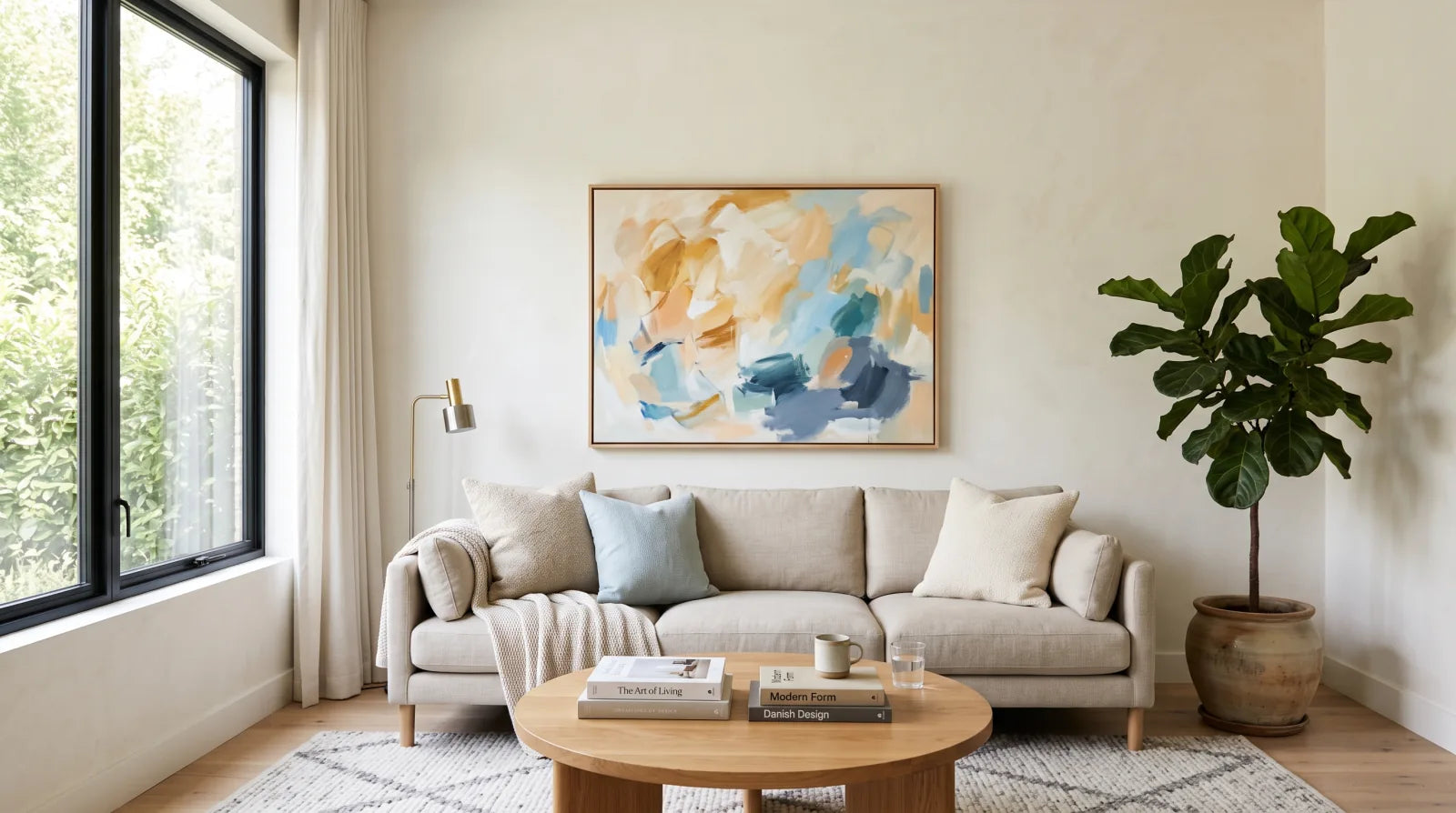 An original abstract painting displayed above a sofa in a bright living room