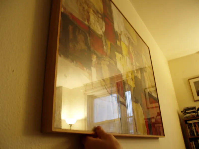Wrong example: a painting shot at an angle with glare and a hand in the frame